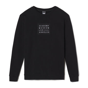 Black sweatshirt with 'Academy Museum Los Angeles' logo on a white background